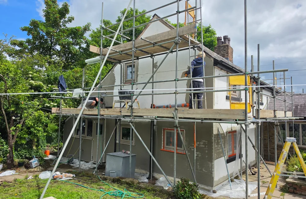 AJM Pro applying the exterior render to this cottage during the project